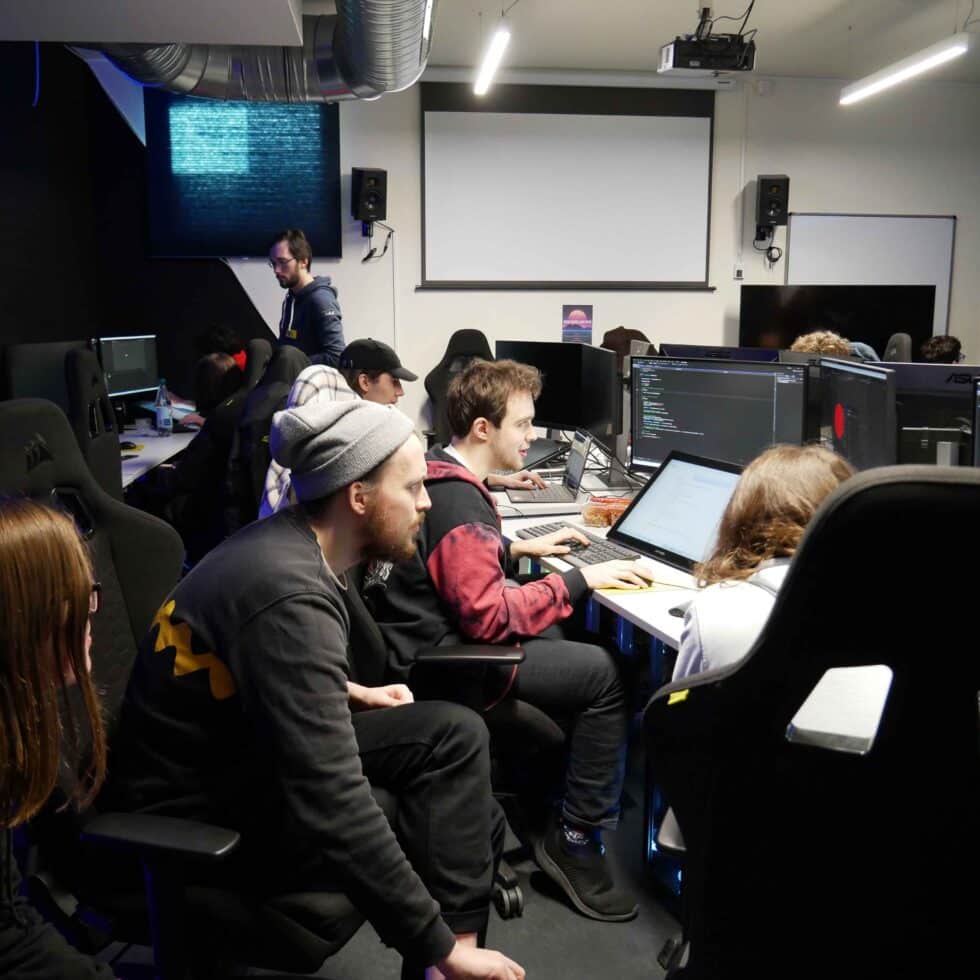 MetStudios students in a room looking at monitors