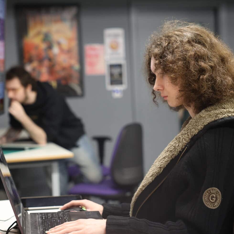 MetStudios student sat at a desk, behind his computer