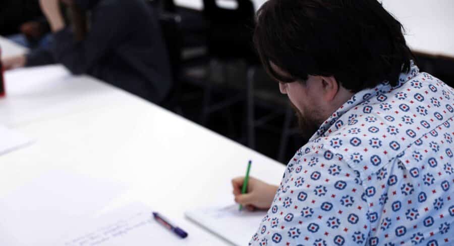MetStudios student writing on paper